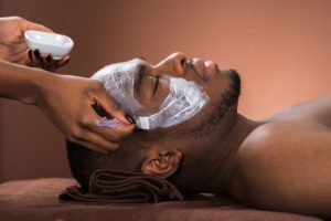 therapist-applying-face-mask-to-man-royalty-free-image-609094134-1547225313